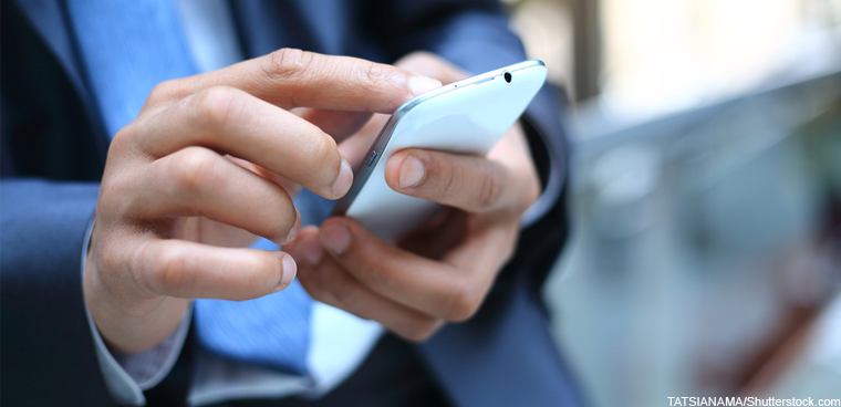 businessman texting (TATSIANAMA/Shutterstock.com)