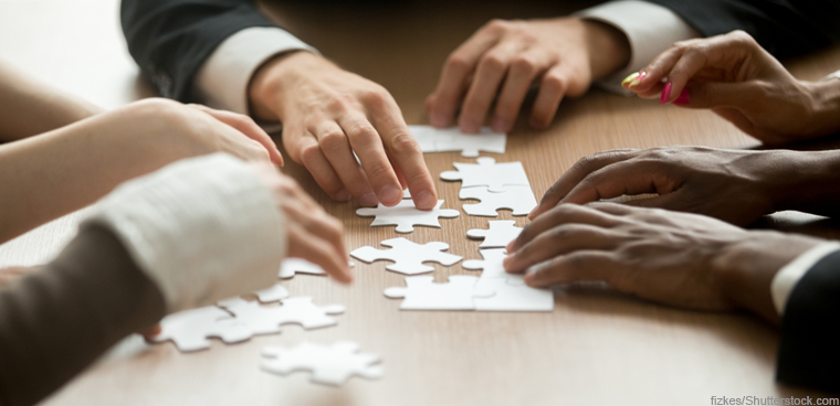 team assembling puzzle (fizkes/Shutterstock.com)