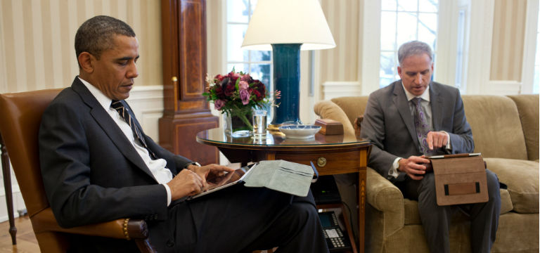 President Obama receives a daily brief via ipad in 2012. White House photo by Pete Souza
