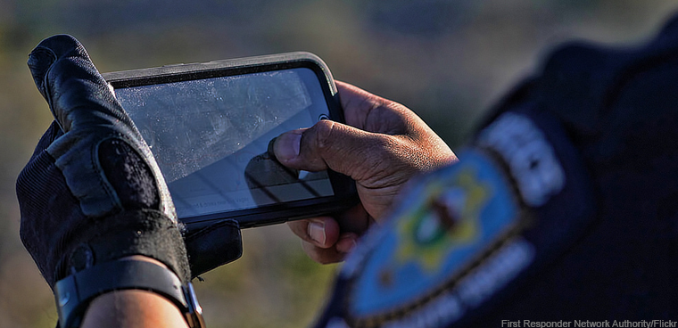 police officer using wireless device (First Responder Network Authority/Flickr)