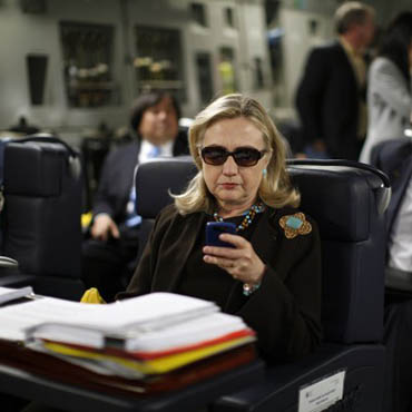 Hillary Clinton using a Blackberry.
