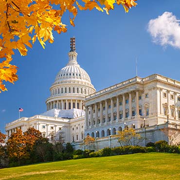 Shutterstock image: the Capitol Building in autumn with orange leaves.