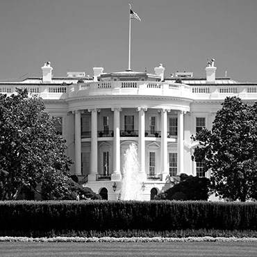 Shutterstock image: black and white image of the White House during the day.