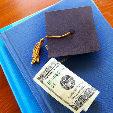 graduation cap with money and notebooks