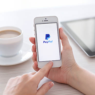 Shutterstock image (by Denys Prykhodov): PayPal on a mobile device. (Required attribution under image: Denys Prykhodov / Shutterstock.com)