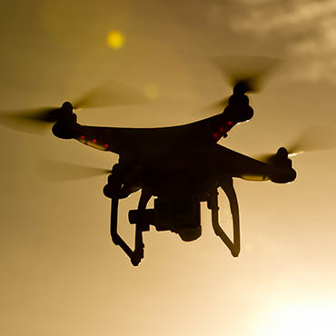 Shutterstock image (by Action Sports Photography): a shadowed UAV drone flying through the air. 