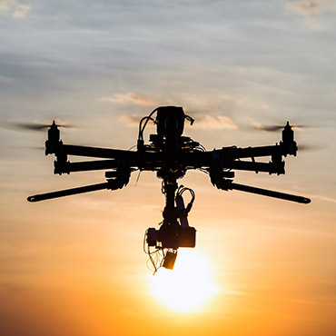 Shutterstock image (by concept w): drone flying into the sunset.