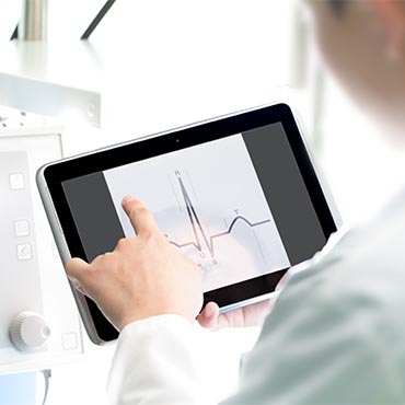 Shutterstock image: medical professional monitoring a patient's heartbeat.