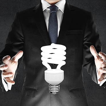 Shutterstock image: businessman grasping the light bulb of innovation.