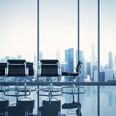 Shutterstock image: an empty board room overlooking the city's skyline.