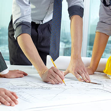 Shutterstock image (by Pressmaster):  drafting a construction plan.