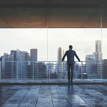 Shutterstock image (by Sfio Cracho): businessman looking at the city.