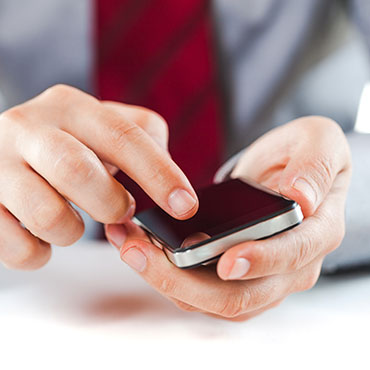 Shutterstock image: businessman using a smart phone.