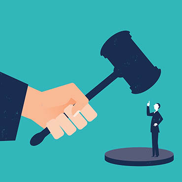 Shutterstock image (by kmlmtz66): businessman confronting a judge's gavel.
