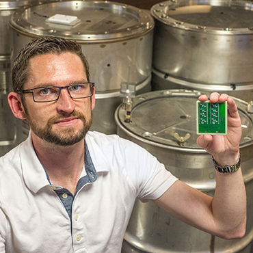 Photo courtesy of Sandia National Labs: Jason Hamlet was on the Sandia National Laboratories team that developed SecuritySeal, a device that attaches to a container and detects tampering.